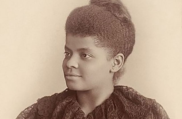 Ida B. Wells. Archival photo of Black woman with hair in top knot, wearing a dark top.