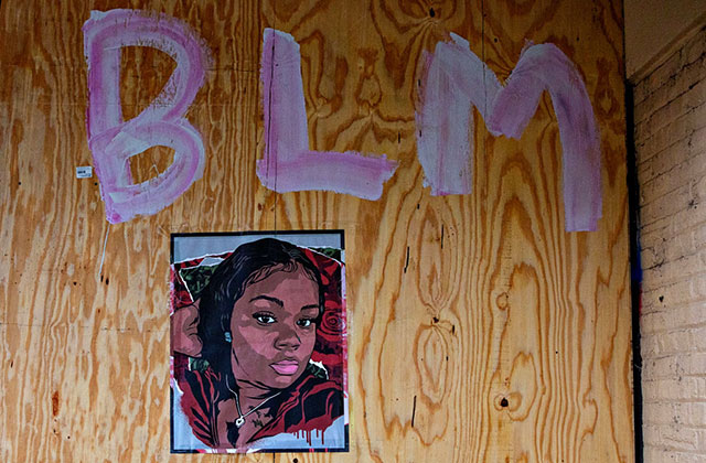 Breonna Taylor. Artwork of Black woman on a wooden board under the letters BLM.