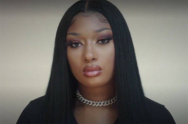 Megan Thee Stallion. Black woman with long dark hair parted down the middle wearing a choker chain and black top.