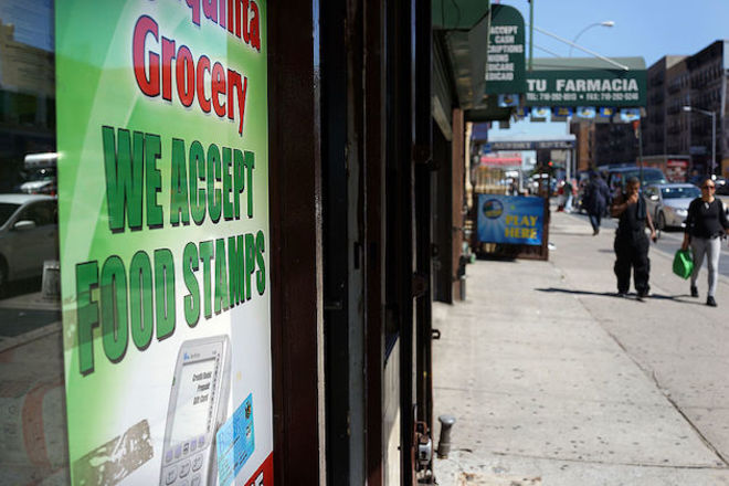 Bronx store window with sign about food stamps