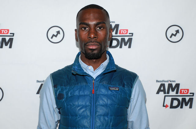 Close up shot of Black man wearing a blue vest