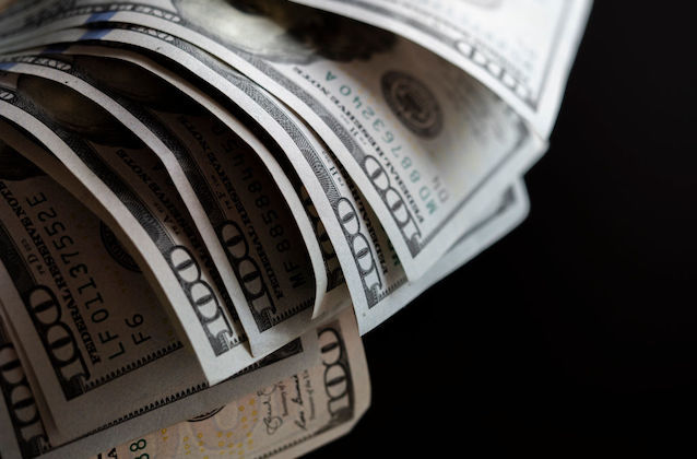 Close-up image of U.S. $100 bills. 