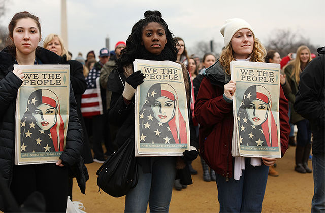 People watch on the National Mall the inauguration of President Donald Trump on January 20, 2017, in Washington, D.C. Washington and the entire world have watched the transfer of the United States presidency from Barack Obama to Trump, the 45th president.