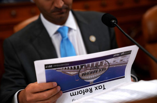 Man holds packet of papers