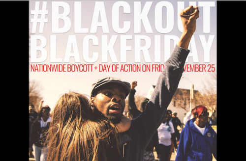 Black man with fist up holding child