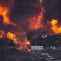 Flames sweep through a rural community at the Blue Cut Fire on August 17, 2016, near Wrightwood, California. An unknown number of homes and businesses have burned and more than 82,000 people are under evacuation orders.