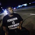 Protester wears a black T-shirt with white writing that says "Ferguson is Everywhere"