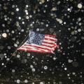 A U.S. flag is bent by the wind as the eye of Hurricane Hermine passes overhead in the early morning hours on September 2, 2016, in Shell Point Beach, Florida. Hurricane warnings have been issued for parts of Florida's Gulf Coast as Hermine makes landfall
