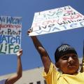 Seven-year-old Omaka Nawicakinciji (R) of the Oglala Lakota Nation in South Dakota participates with his mother Heather Mendoza (L) during a rally on Dakota Access Pipeline August 24, 2016, outside U.S. District Court in Washington, D.C.