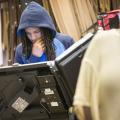 Young Black man with dredlocks and a blue hoodie votes in Ferguson