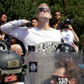 A White man in sunglasses and a White shirt makes a slashing motion across his neck during the "Unite the Right" rally in Charlottesville, Virginia