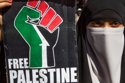 A woman holding a free Palestine Placard at a Black Lives matter protest in central London on July 18, 2020.