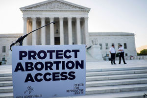 U.S. Supreme Court and protest sign supporting abortion